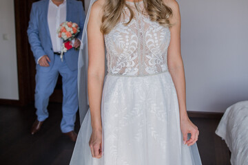 groom with bride and wedding bouquet in hands