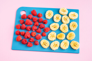 Step by step instruction. Homemade raspberry ice cream. Step 2. Slice the banana. Home cooking concept. Hobby and activities at home. 