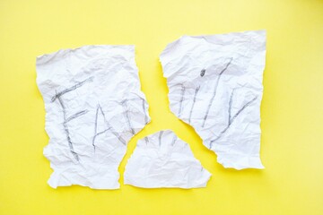 The text of the family on a white sheet of paper in a cage on a bright yellow background. Destruction and divorce. Step by step.