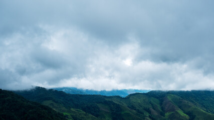 Obraz premium Landscape image of greenery rainforest mountains and hills on cloudy sky