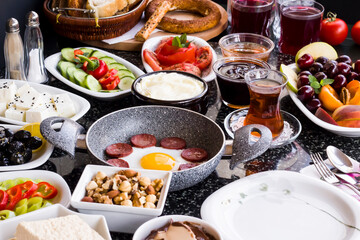 Traditional Turkish Breakfast with sausage egg pan on granite marble table.Close and large view.     