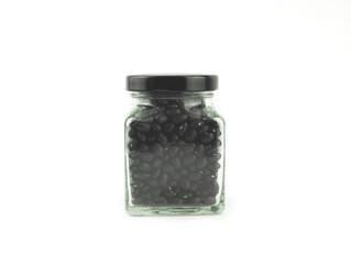 Black gram (vigna mungo) in a glass bottle with lid isolated on a white background. High vitamins and iron.  Healthy nutrition food concept..