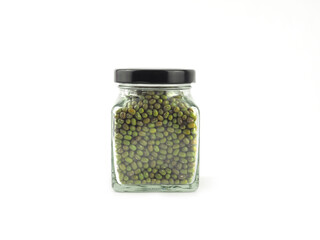 Mung beans in a glass bottle with black lid isolated on a white background.  Healthy nutrition food concept..