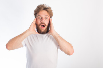 portrait of a young guy with rusty hair and tanned skin who is fooling around on camera. space for text. isolate on a white background