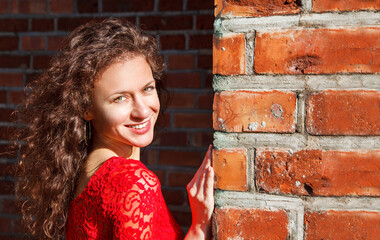 portrait of a young brunette girl in a red dress