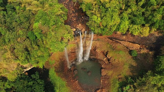 Tad Tayicsua Falls and lush tropical jungle in Asia, Laos, Champasak, Boloven Plateau, on a sunny day.