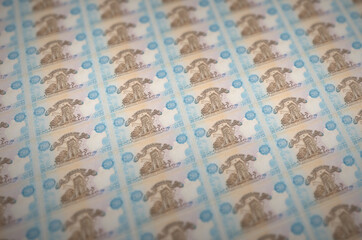 200 Ukrainian hryvnias bills printed in illegal money production conveyor. Collage of many fake...
