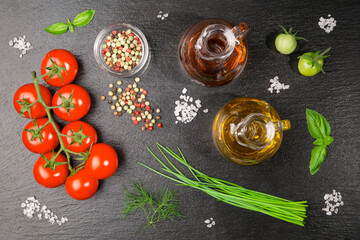 Tomato salad ingredients on a slate slab