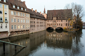 Fototapeta na wymiar Heilig-Geist-Spital, historical hospital on Pegnitz river in old town of Nuremberg, Bavaria, Germany. November 2014