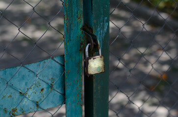Padlock on a metal gate.