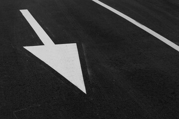 white arrow on asphalt to define direction