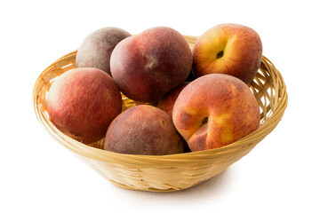 Fresh peaches in basket on white