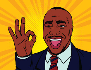 Colored vector illustration in pop art comic style. Happy male face with an approved sign. African American man shows his agreement with a gesture. Black male businessman in suit.