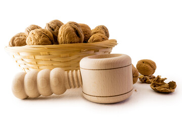 Walnuts in basket with crushing tool
