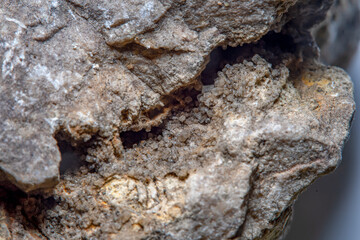 Stone surface texture at high magnification with numerous microscopic formations of natural quartz crystals in cracks