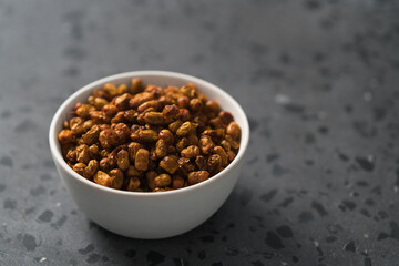 dried seaberry buckthorn in white bowl on terrazzo countertop with copy space