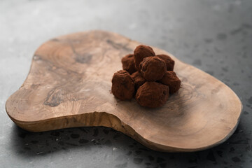 Handmade chocolate truffles on olive wwod board