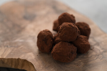 Handmade chocolate truffles on olive wwod board