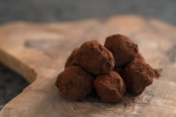 Handmade chocolate truffles on olive wwod board