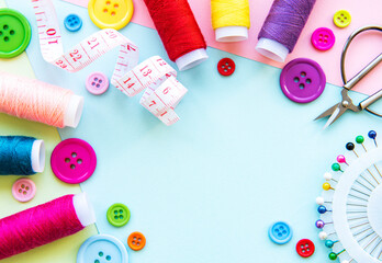 Sewing accessories on a blue pastel background