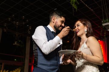 newly married couple cutting the wedding cake
