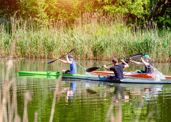Three guys floating in a canoe on the river