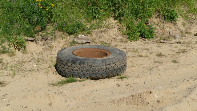 the old wheel of the car. A violation of ecology