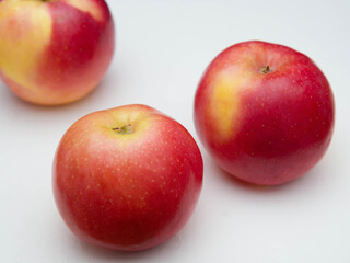 Fototapeta na wymiar Three red ripe juicy apples on white background.