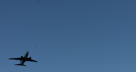 Landing plane on clear blue sky. Under view. Turistic and transportation aviation business.