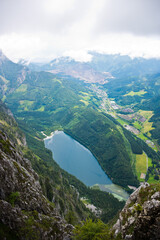 View from the top of the mountain to Leopoldsteinersee mountain lake and Eisenerz with the Erzberg in beautiful alpine landscape.