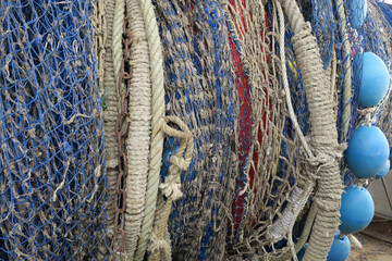 collection of blue fishing nets and a chain of blue floaters