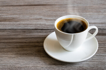 Hot white coffee cup on grunge vintage wooden tabletop