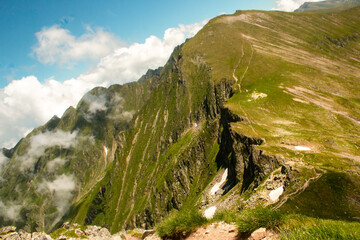Clouds over mountain peaks. Majestic scenery on high altitude.