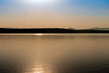 View of the opposite shore of the lake in the afternoon.