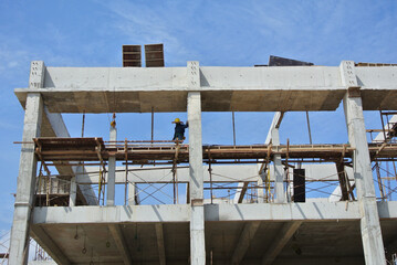 SERDANG, MALAYSIA -MAY 13, 2016: Construction site in progress at Serdang, Malaysia during the daytime. Workers busy with their task installing formwork and reinforcement bar.     