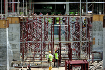 SERDANG, MALAYSIA -MAY 13, 2016: Construction site in progress at Serdang, Malaysia during the daytime. Workers busy with their task installing formwork and reinforcement bar.     