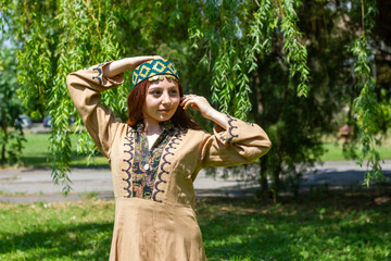 Armenian young woman in traditional clothes in the forest
