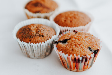 homemade muffins with different fillings on a light background. food for children's parties and tea