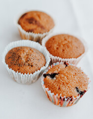 homemade muffins with different fillings on a light background. food for children's parties and tea