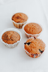 homemade muffins with different fillings on a light background. food for children's parties and tea