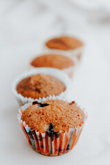 homemade muffins with different fillings on a light background. food for children's parties and tea