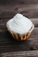 homemade muffins with white cream on a dark background