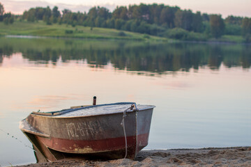 Boat on the lake at sunset in Siberia, Russia.