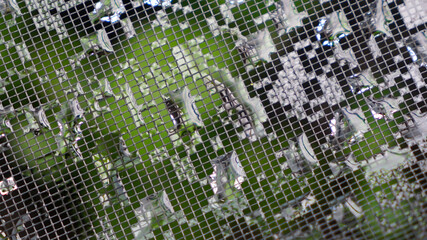 Abstract pattern of green, grey and silver water droplets on insect screen.