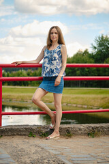 Girl in blouse and skirt having rest at country recreation area, enjoying fresh air and calmness