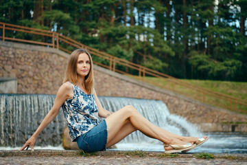 Girl in blouse and skirt having rest at country recreation area, enjoying fresh air and calmness