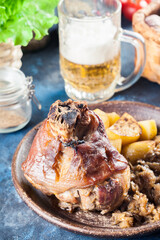 Pork knuckle with fried sauerkraut and baked potatoes