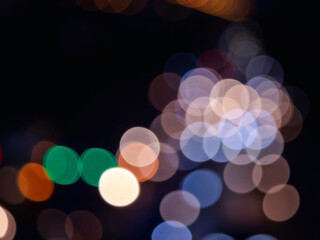 Abstract bokeh night light background, blurred lights traces from cars on road, defocused city traffic on street at night