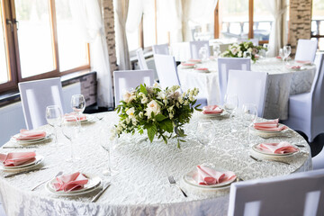 Festive table setting with wine glasses, and fresh flowers