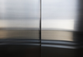 Elevator door, detail of a shiny metallic background., The surface of stainless steel mirror ,...
